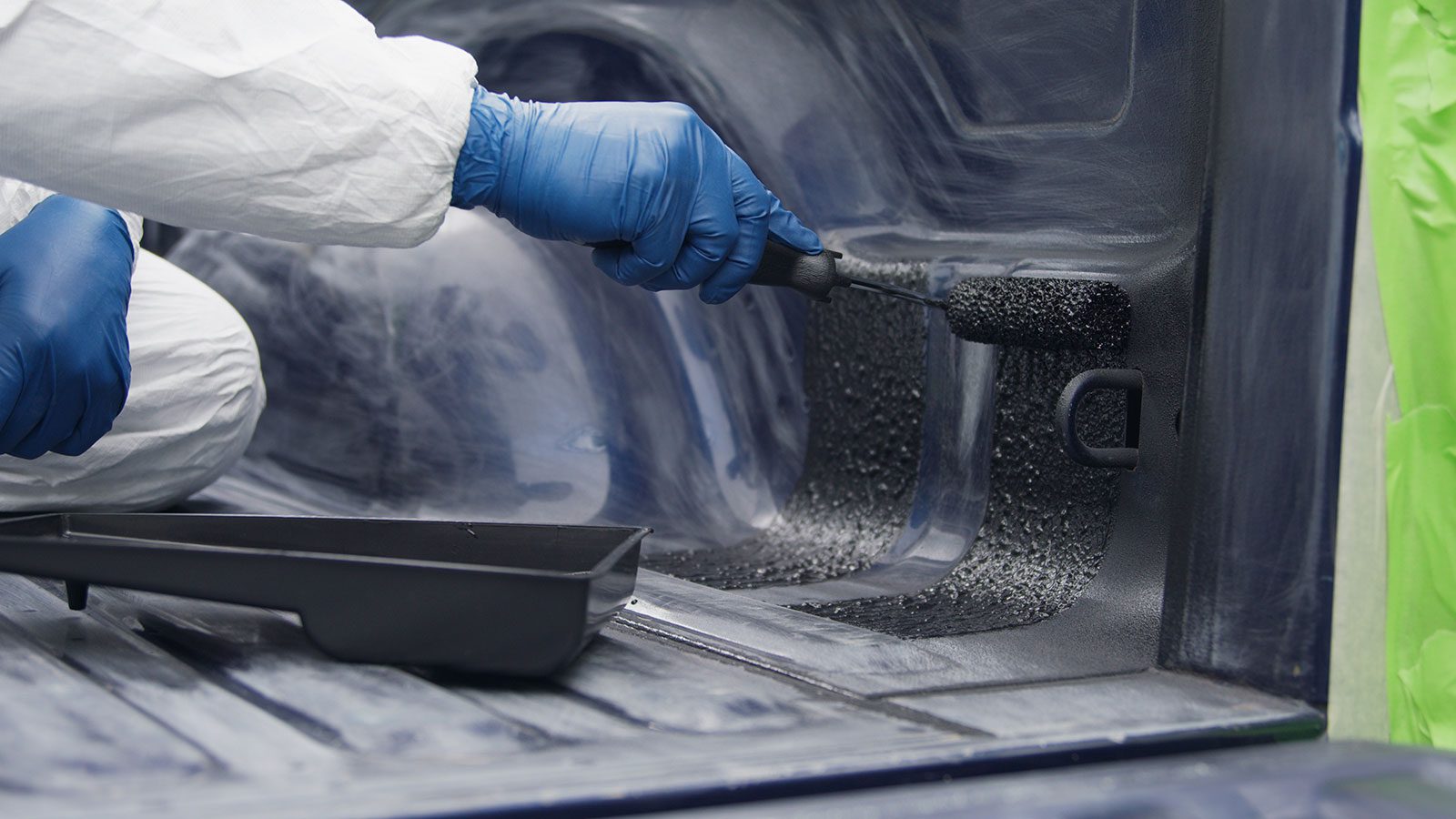 roller applying truck bed liner